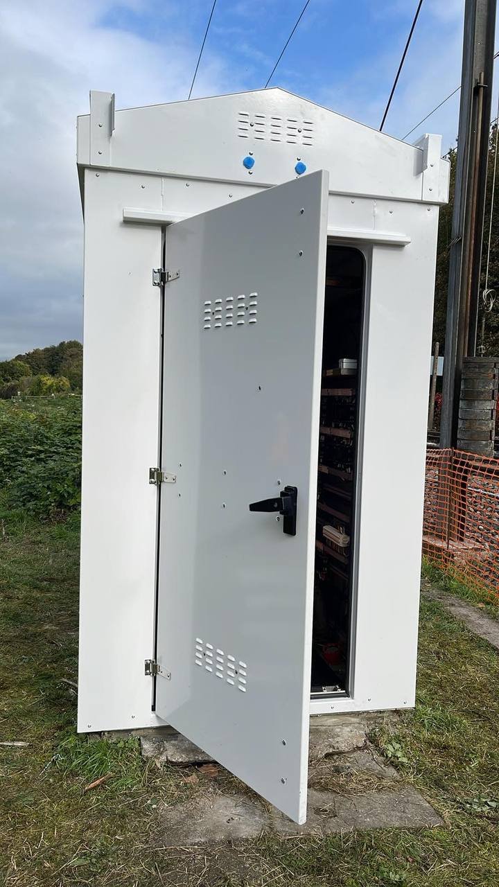 SafeBox RT cabinet with the door open on the equipment rack
